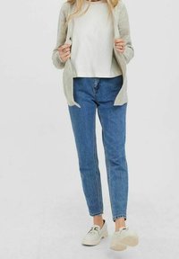 Jasnoszary sweter rozpinany na biały t-shirt, niebieskie jeansy z wysokim stanem i białe trampki. Sweter ma miękką fakturę i otwarty przód.