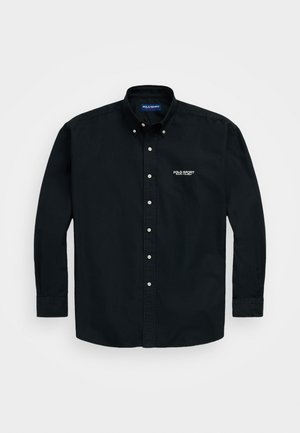 Black button-up shirt with long sleeves, made of cotton. Features a classic collar and white "POLO SPORT" logo on the left chest area.