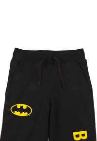 Zwarte sweatpants met een gele Batman-logo en een accent van de letter "B". Gemaakt van zachte stof, met een elastische tailleband en zijzakken.