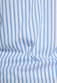 Cotton fabric with alternating light blue and white stripes, featuring a smooth, soft texture and subtle wrinkles throughout.