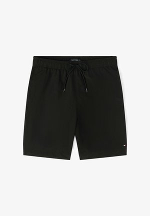 Shorts de bain pour hommes noirs avec taille élastique et cordon de serrage, présentant un petit logo sur la partie inférieure de la jambe gauche.