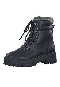 Bottines à lacets noires en simili cuir, avec une bordure en fausse fourrure, une semelle à crans épaisse, et des œillets en métal argenté pour les lacets.