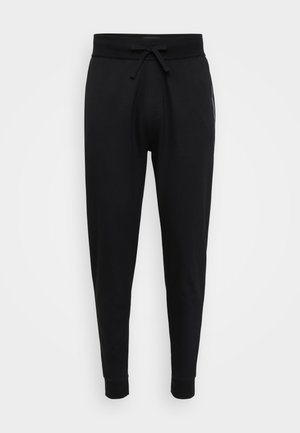 Black jogger pants made of soft fabric, featuring an elastic waistband with drawstring, tapered legs, and ribbed cuffs.