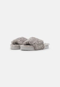 Fuzzy grey slide slippers with an open toe and plush texture, featuring a thick white sole and stitched detailing.