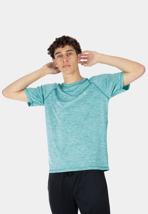 Short-sleeve athletic shirt in light teal, featuring a heathered texture, raglan sleeves, and a small logo on the chest. Black pants shown.