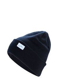 Dark blue knit beanie made from soft material. Features a folded cuff and a small rectangular label with a logo on the side.
