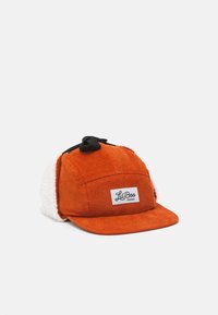 Orange corduroy cap with a black strap and white fleece ear flaps. Features a rectangular label with "Lil Boo" logo on the front.