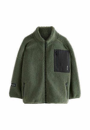 Fleece jacket in olive green with a high collar, zippered chest pocket, and two front pockets. Textured fabric with a soft finish.