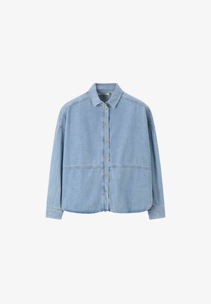 Light blue denim shirt with long sleeves, button front, pointed collar, and two horizontal seams across the chest. Smooth texture, casual design.
