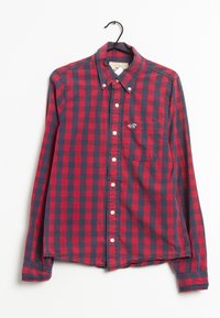 Red and navy checkered long-sleeve shirt with button-down collar and chest pocket, made of cotton fabric with a smooth texture and white buttons.