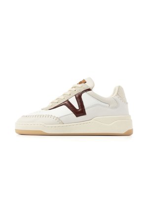 Low-top beige sneaker with cream sole, brown "V" logo on side, stitched detailing, and light tan outsole shown in right profile.