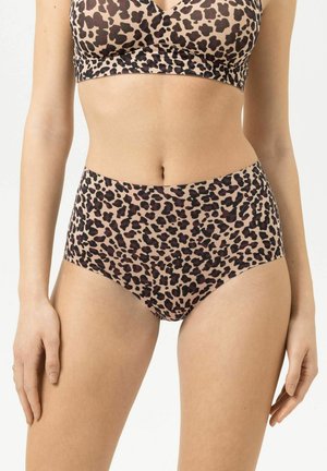 Woman wearing high-waist leopard print underwear and matching bra, standing with arms relaxed by her sides.