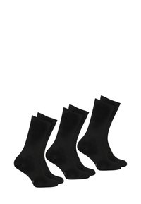 Paquet de quatre chaussettes noires en coton avec un haut lisse et côtelé et un orteil renforcé. Chaque chaussette a un design classique de longueur cheville.