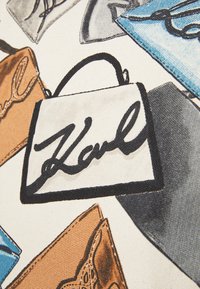 Canvas fabric featuring illustrations of colorful handbags in various shapes with prominent black outlines and signatures. Colors include white, brown, and blue.