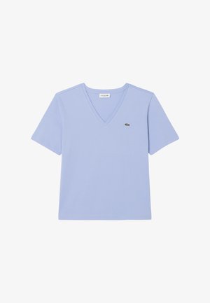Camiseta de manga corta en V de color azul claro con un pequeño logo de cocodrilo verde de Lacoste en el lado izquierdo del pecho.