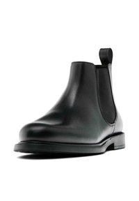 Botte Chelsea en cuir noir avec une texture lisse, des panneaux latéraux élastiques, un bout arrondi et un petit talon carré.