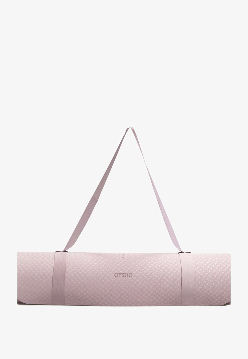 Hellrosa Yogamatten-Tasche mit strukturiertem Muster, ausgestattet mit zwei verstellbaren Schultergurten und einem Logo, entworfen zum Tragen von Matten.