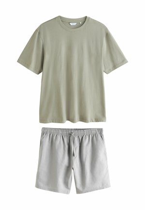 Olive green cotton t-shirt with short sleeves and crew neck, paired with light gray shorts featuring an elastic waistband and drawstring.