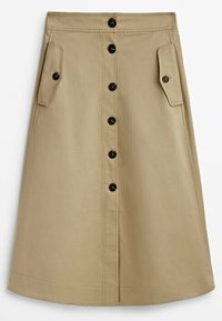 Jupe trapèze beige avec boutons noirs à l'avant et deux poches à rabat latérales, longueur genou, en coton.