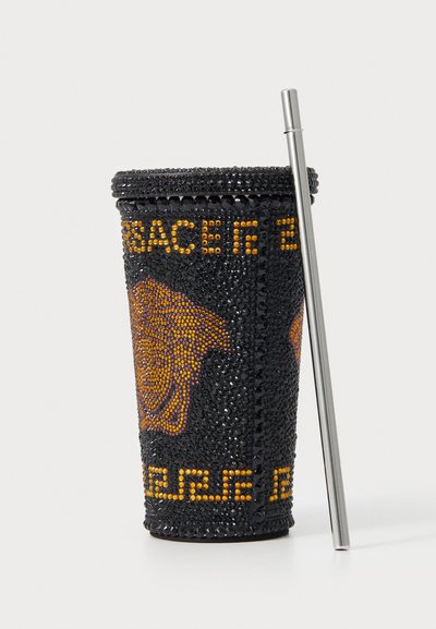 Black beaded cup adorned with a gold and orange Medusa design, featuring a silver metal straw and a textured, sparkling surface.