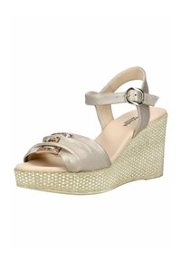 Sandale compensée avec plateforme en tissu beige, bride de cheville métallique avec boucle, et deux brides avant ornées de décorations dorées et de pierres précieuses.