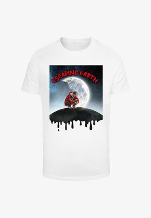 White t-shirt featuring a graphic design of a figure in a red outfit crouching on a black hill with a moon in a starry sky background.