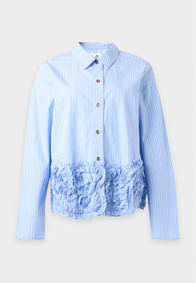 Chemise bleu clair à manches longues avec rayures verticales blanches et détails texturés à volants sur le bas devant.