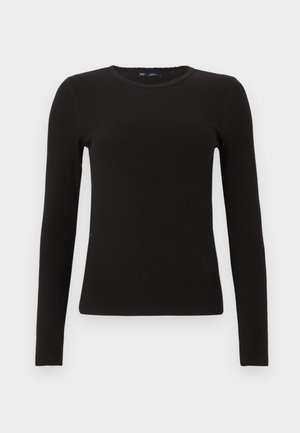 Pull noir en maille côtelée à manches longues avec un col rond, coupe ajustée et texture subtile, présenté sur un fond blanc uni.