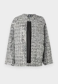 Veste tissée noire et argent avec un col rond, une ouverture à l'avant et des manches trois-quarts. Tissu texturé avec une finition scintillante.