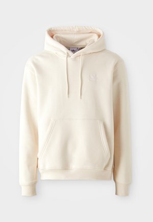 Cream-colored hoodie made of soft fabric, featuring a front pocket, drawstring hood, and a small white logo on the chest.