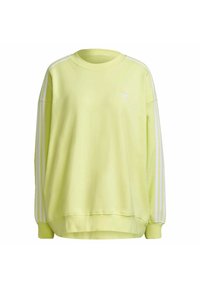 Žlutá mikina s dlouhými rukávy, kulatým výstřihem a bílými třemi pruhy na ramenech. Měkká látka, volný střih, malá logo na hrudi.