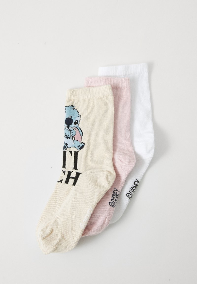 Set di tre calzini: uno beige con un personaggio blu e testo nero, uno rosa e uno bianco. Tessuto testurizzato, lunghezza alla caviglia.