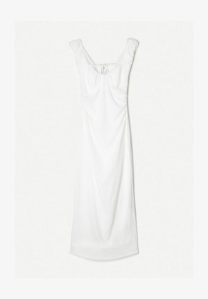White dress with a fitted body and flowing skirt. Features ruched detail and a tie at the back, with a scoop neckline and soft texture.