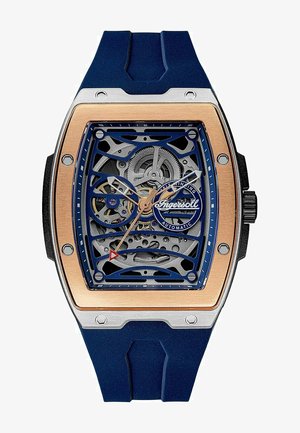 Skeleton-Automatik-Uhr mit blauem Gummiband, silbernem Gehäuse und Roségold-Akzenten. Transparente Zifferblatt, das die komplizierte innere Mechanik zeigt.