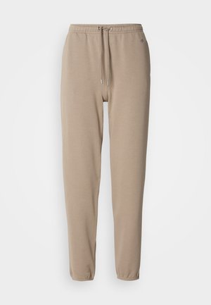 Joggers beiges en mélange de coton doux, dotés d'une taille élastique avec cordons de serrage et de jambes fuselées. Design simple sans motifs.