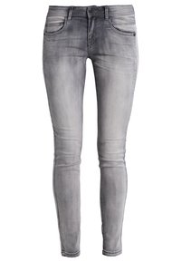 Jeans skinny grises con un lavado desgastado, diseño de cinco bolsillos y detalles de costura sutiles. Hechos de denim con una textura suave.