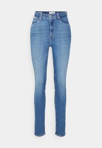 Jeans skinny a vita alta blu con tasche anteriori e posteriori, passanti per la cintura e chiusura con bottone e zip.