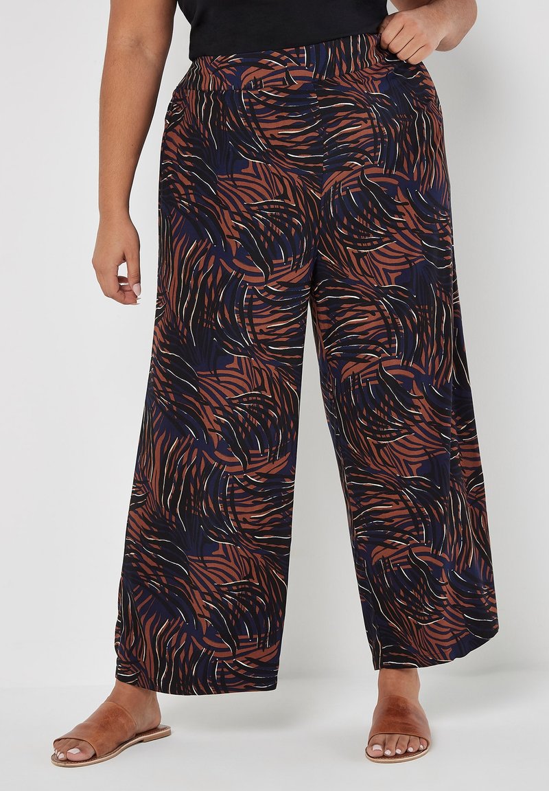 Weite Hosen mit marineblauem Grund und einem wirbelnden Muster in Rost und Creme. Hergestellt aus einem weichen, leichten Stoff mit elastischem Bund.