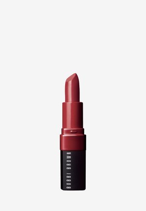 Rossetto Bobbi Brown in un tubo cilindrico. Il tappo è di un rosso lucido, mentre il corpo è nero opaco con testo bianco. La punta è di una profonda tonalità mauve.