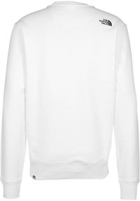 Sudadera blanca con puños y dobladillo acanalados. Presenta un pequeño logo negro en la parte superior de la espalda. Fabricada con un tejido texturizado para mayor comodidad.