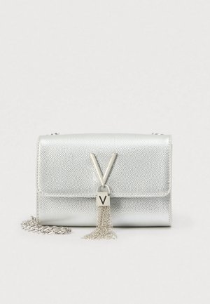 Silver textured leather crossbody bag with metal V logo and dangling chain tassel, featuring a silver chain strap.