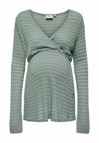 Langsleeve, wikkeltop in zacht groen met gestructureerde strepen. Heeft een V-halslijn en een gathering in de taille voor een getailleerd silhouet.