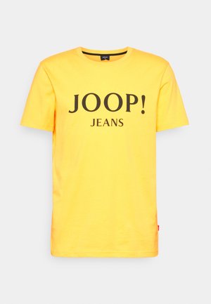 T-shirt jaune en coton à manches courtes avec texte noir "JOOP! JEANS" imprimé sur la poitrine et col rond.