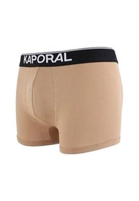 Boxers en coton beige avec une ceinture noire arborant l'inscription blanche "KAPORAL", conçus avec une texture lisse et un ajustement près du corps.