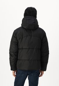 Black puffer jacket with a hood, featuring a quilted design and horizontal seams. The fabric appears smooth and insulated.