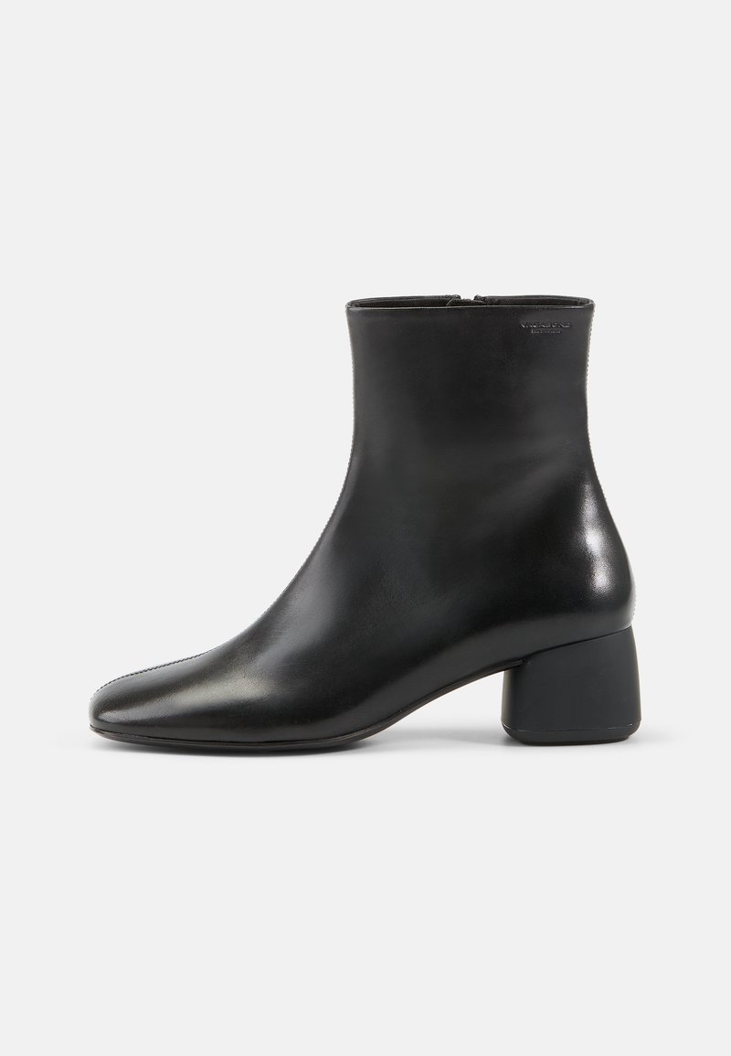 Black leather ankle boot with a rounded toe, zip closure, and a chunky black heel. Smooth texture and minimalistic design.