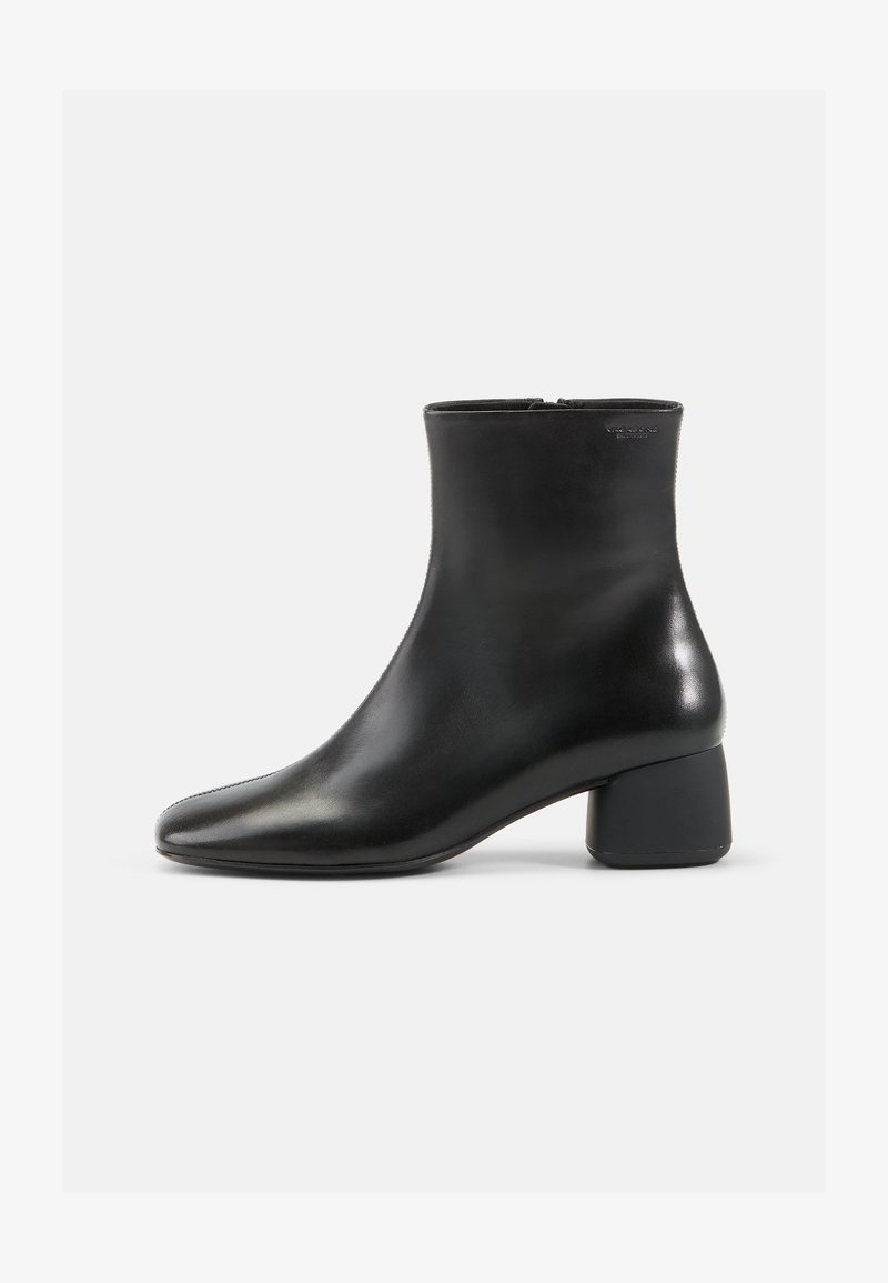 Black leather ankle boot with a rounded toe, zip closure, and a chunky black heel. Smooth texture and minimalistic design.