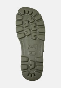 Green rubber shoe sole with deep treads, featuring the brand name "CAMPER" and size "42" embossed in the center.