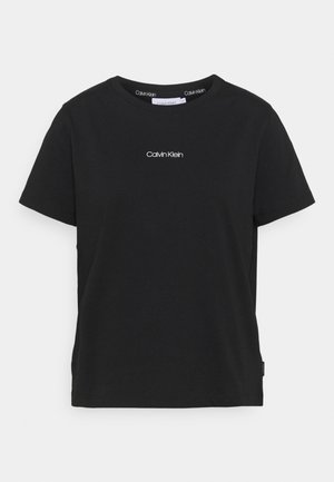 Schwarzes Kurzarm-T-Shirt von Calvin Klein mit weißem Logo in der Mitte der Brust und rundem Ausschnitt.