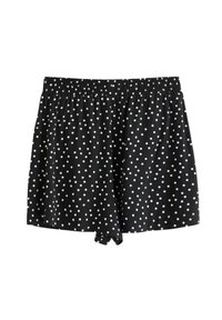Sorte shorts med hvide prikker, der har et elastisk talje og en løs pasform. Stoffet har en glat tekstur.